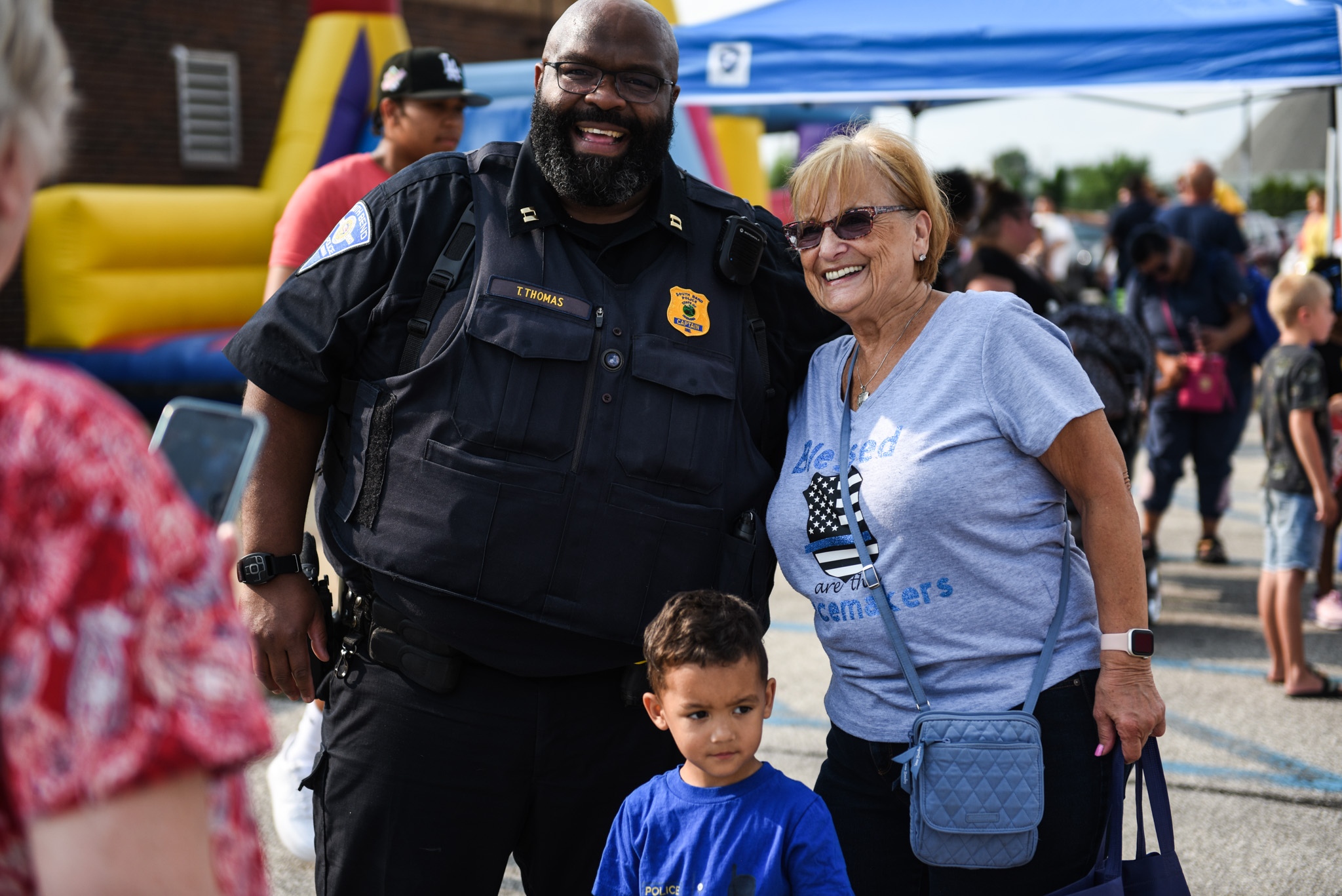 a police officer with a woman and child