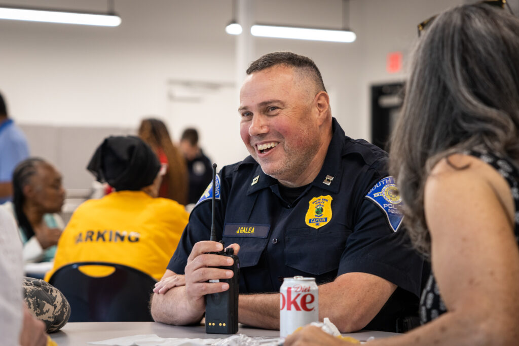 an SBPD officer holding a walkie talkie
