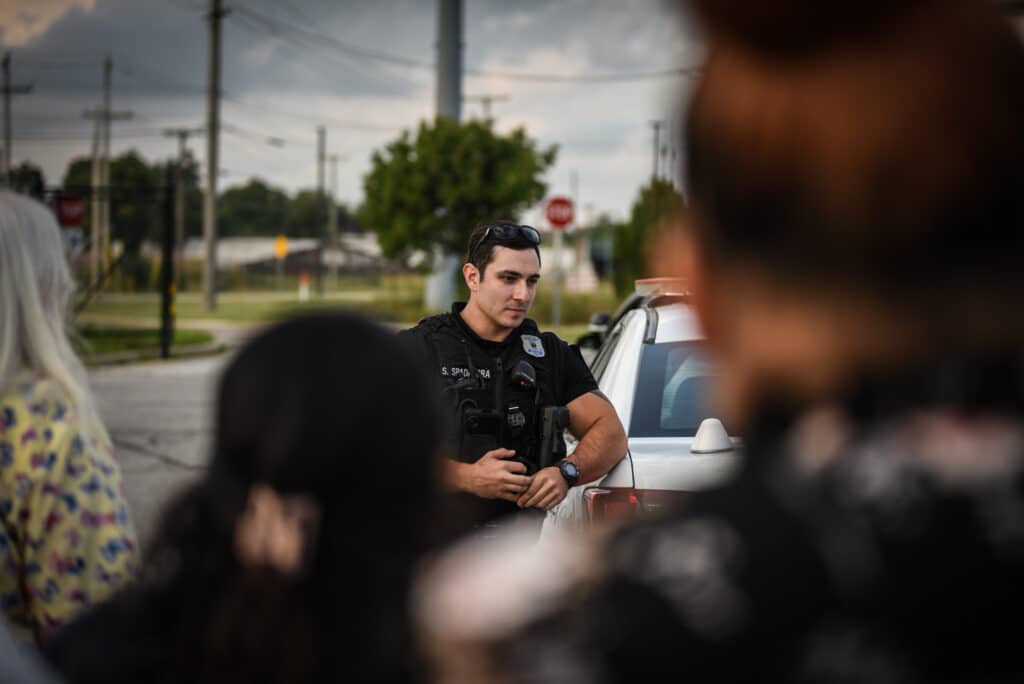 an SBPD officer talking to a group of people